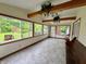 Bright sun room featuring tile floors, wood beam ceiling, and multiple windows for natural light at 1949 Shenandoah Pl, Indianapolis, IN 46229