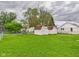 Spacious green backyard with two white storage sheds at 209 E 35Th St, Anderson, IN 46013