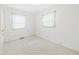 Empty bedroom with two windows, neutral carpet, and closet for a calming atmosphere at 209 E 35Th St, Anderson, IN 46013