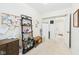 Bright, tidy bedroom featuring a decorative shelving unit and view of the adjacent bathroom at 209 E 35Th St, Anderson, IN 46013