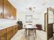 A dining room featuring wood cabinets, a table with four chairs, and a ceiling fan at 209 E 35Th St, Anderson, IN 46013