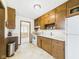 Charming kitchen equipped with wood cabinetry, appliances, and linoleum flooring at 209 E 35Th St, Anderson, IN 46013