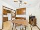 View of the kitchen and dining room with wooden table, cabinets, and linoleum flooring at 209 E 35Th St, Anderson, IN 46013