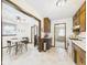 View of the kitchen and dining area and their cabinetry, appliances, and linoleum flooring at 209 E 35Th St, Anderson, IN 46013