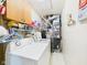 Functional laundry room with washer, dryer, storage shelves, and basic utilities at 209 E 35Th St, Anderson, IN 46013