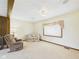 Cozy living room featuring a comfortable recliner, couch, large window, and carpeted flooring at 209 E 35Th St, Anderson, IN 46013