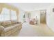 Bright living room featuring neutral carpet, large windows with decorative curtains and a comfortable seating arrangement at 209 E 35Th St, Anderson, IN 46013