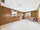 Bright room with wood paneling, windows and neutral carpet at 209 E 35Th St, Anderson, IN 46013