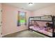 Bedroom with a bunk bed, window, and soft pink walls at 2444 S Brandywine Ct, Greenfield, IN 46140