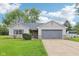 Charming ranch-style home with an attached two-car garage, a well-manicured lawn, and professional landscaping at 2444 S Brandywine Ct, Greenfield, IN 46140