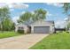 Charming ranch-style home with an attached two-car garage and driveway, as well as a well-manicured lawn at 2444 S Brandywine Ct, Greenfield, IN 46140