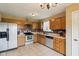 View of the kitchen featuring tile flooring, wood cabinets and modern appliances at 2444 S Brandywine Ct, Greenfield, IN 46140