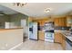 Traditional kitchen with stainless steel appliances, tiled floor, and wooden cabinets at 2444 S Brandywine Ct, Greenfield, IN 46140