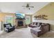 Spacious living room featuring a stone fireplace, large windows, built-in shelving, and comfortable seating at 2444 S Brandywine Ct, Greenfield, IN 46140