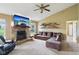 Spacious living room featuring a stone fireplace, a TV, built-in shelving, and comfortable seating at 2444 S Brandywine Ct, Greenfield, IN 46140