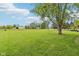 Large, grassy yard featuring a barn and surrounding greenery in a home for sale at 2444 S Brandywine Ct, Greenfield, IN 46140