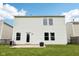 Rear view of a house with a patio, well-kept lawn, and a door for easy outdoor access at 2545 Harvest Moon Dr, Greenwood, IN 46143