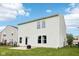 Rear view of a home featuring white siding, a patio, and a well-manicured lawn at 2545 Harvest Moon Dr, Greenwood, IN 46143