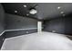 Finished basement with gray carpet, dark walls and a projector for a theater-like experience at 2545 Harvest Moon Dr, Greenwood, IN 46143