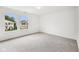 Bright bedroom with large windows offering an exterior view and neutral carpeting at 2545 Harvest Moon Dr, Greenwood, IN 46143