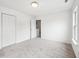 Bright bedroom with neutral carpet, white walls, trim, and a door leading to the hallway at 2545 Harvest Moon Dr, Greenwood, IN 46143
