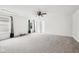 Spacious bedroom with large windows, ceiling fan, and neutral carpet at 2545 Harvest Moon Dr, Greenwood, IN 46143