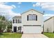 Charming two-story home featuring a large garage, manicured lawn, and classic white siding at 2545 Harvest Moon Dr, Greenwood, IN 46143
