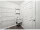Functional laundry room features shelving, a sink, and white painted walls and trim at 2545 Harvest Moon Dr, Greenwood, IN 46143