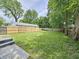 A spacious backyard with a new wooden fence and mature trees at 2737 S Roena St, Indianapolis, IN 46241