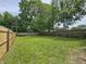 A spacious backyard with a new wooden fence and mature trees at 2737 S Roena St, Indianapolis, IN 46241