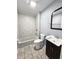 A clean bathroom with tiled shower, toilet, and dark vanity with sink at 2737 S Roena St, Indianapolis, IN 46241