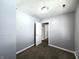 A simple bedroom with neutral walls, a door, and brown carpet at 2737 S Roena St, Indianapolis, IN 46241