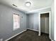 A simple bedroom with neutral walls, a window, a closet, and wall hooks at 2737 S Roena St, Indianapolis, IN 46241