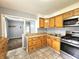 Kitchen with wooden cabinets, stainless steel range, and tiled floor at 2737 S Roena St, Indianapolis, IN 46241