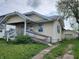 Charming single-story home featuring vinyl siding, a covered porch, a ramp, and a detached garage in the back at 2806 Jefferson St, Anderson, IN 46016