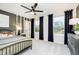 A modern bedroom with an accent wall, three windows, and black-out curtains at 3873 Goodwin Dr, Zionsville, IN 46077