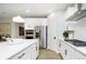 Modern kitchen featuring stainless steel appliances, white cabinets, and a large center island at 3873 Goodwin Dr, Zionsville, IN 46077