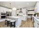 Beautiful kitchen featuring white cabinets, a large island, stainless steel appliances, and hardwood floors at 3873 Goodwin Dr, Zionsville, IN 46077