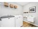 Bright laundry room featuring a utility sink, and a Maytag washer and dryer at 3873 Goodwin Dr, Zionsville, IN 46077
