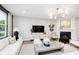 Cozy living room with a fireplace, modern furnishings, and a large flat-screen TV at 3873 Goodwin Dr, Zionsville, IN 46077