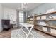 Bright home office with custom shelving, a modern desk, and a comfortable armchair at 3907 Goodwin Dr, Zionsville, IN 46077