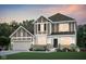 Charming two-story home featuring a well-manicured lawn and a brick-accented facade at 3924 Goodwin Dr, Zionsville, IN 46077
