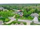Aerial view of a beautiful home surrounded by mature trees and lush landscaping at 3996 Brockton Manor N Dr, Greenwood, IN 46143
