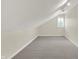 View of the finished attic space with neutral carpet and trim, lit by track lighting at 3996 Brockton Manor N Dr, Greenwood, IN 46143