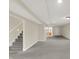 Open basement design with stairs leading to the upper level and a doorway leading to another room at 3996 Brockton Manor N Dr, Greenwood, IN 46143