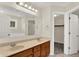 Bathroom featuring double sinks, wooden cabinets and a view to the bath at 3996 Brockton Manor N Dr, Greenwood, IN 46143
