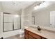 Well-lit bathroom with oak cabinets, framed mirror, and tub shower combo at 3996 Brockton Manor N Dr, Greenwood, IN 46143