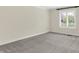 Bedroom with neutral carpet, trim, and paint, plus a window with white shutters at 3996 Brockton Manor N Dr, Greenwood, IN 46143