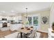 Cozy dining area showcasing white cabinets, black countertops and stainless appliances with modern table and chairs at 3996 Brockton Manor N Dr, Greenwood, IN 46143