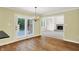 Bright dining area with hardwood floors, French doors leading to a patio, and an open view into a cozy living room at 3996 Brockton Manor N Dr, Greenwood, IN 46143